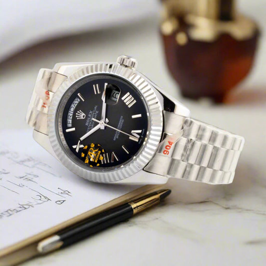 Silver watch with black dial on a white background